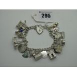 A Curb Link Charm Bracelet, to hallmarked silver padlock clasp, suspending numerous novelty charm