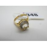 A Four Claw Set Dress Ring, with pear shape centre between plain shoulders (finger size L) (3g).