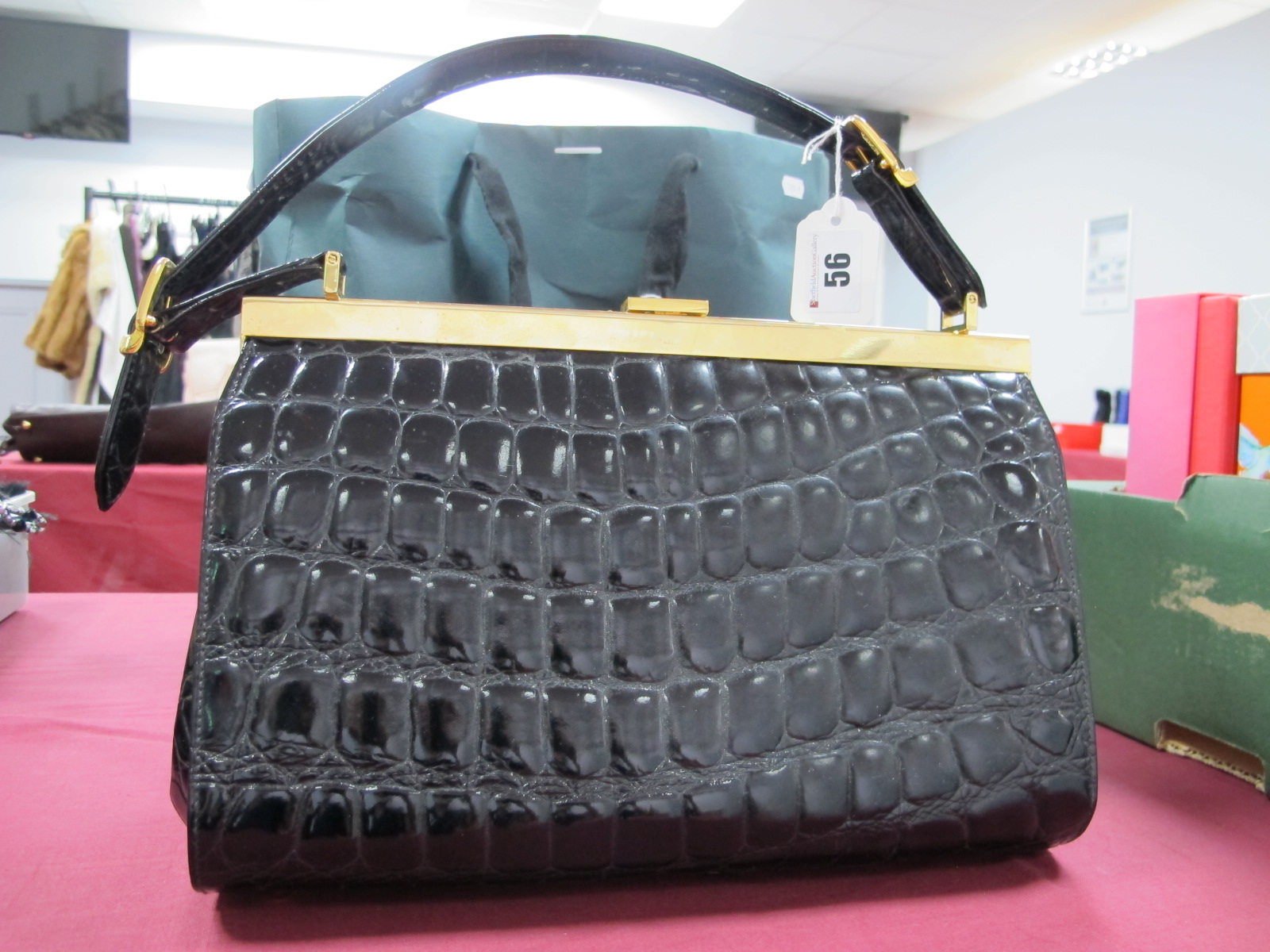A Crombie Black Patent Crocodile Print Leather Classic Handbag, with flat buckled handle and gilt