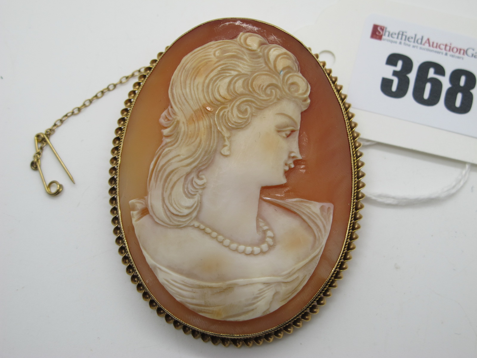A Large 9ct Gold Oval Shell Carved Cameo Brooch, depicting female profile, collet set.