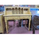 A Pine Desk, with interior pigeon holes, small drawers over two drawers, on turned legs, 106cm