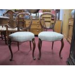 A XIX Century Set of Four Walnut Salon Chairs, with carved centre rails, upholstered seats, on