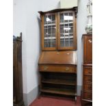 An Early XX Century Oak Bureau Bookcase, with serpentine pediment, twin lead glazed doors over