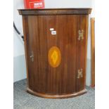 A Mahogany Corner Wall Cupboard, with shell patina inlay to curved door, 66cm high.