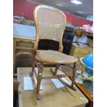 A XIX Century Ash Rocking Chair, with a caned back and seat, turned legs on rockers.
