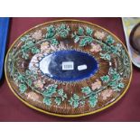 A XIX Century Majolica Oval Pottery Plate, with floral decoration to naturalistic boarder, 34cm