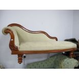 A XIX Century Mahogany Framed Chaise Longue, with wavy back, turned legs, re-upholstered in a pastel