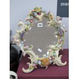 A Continental Freestanding Dressing Table Mirror, with porcelain surround heavily encrusted with