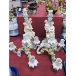 A Pair of Continental Porcelain Three Branch Candleabra, the heavily floral encrusted branches on