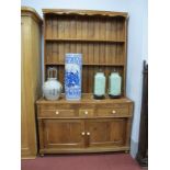 A XIX Century Pitch Pine Dresser, with three drawers over cupboard doors and turned legs, 129cm
