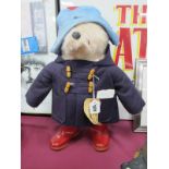 Paddington Bear, wearing purple duffel coat and red wellingtons, bearing 'Darkest Peru' label.