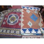 A Middle Eastern Tassled Wool Rug, with octagonal central motif on claret ground within geometric