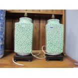 A Pair of Chinese Green & White Pottery Table Lamps, on hardwood stands.