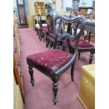 A XIX Century Set of Six Mahogany Chairs, with shaped carved centre rail, drop in seats, on turned