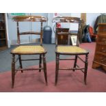 A Pair of XIX Century Painted Rosewood Bedroom Chairs, with shaped top rails, caned seats, on turned