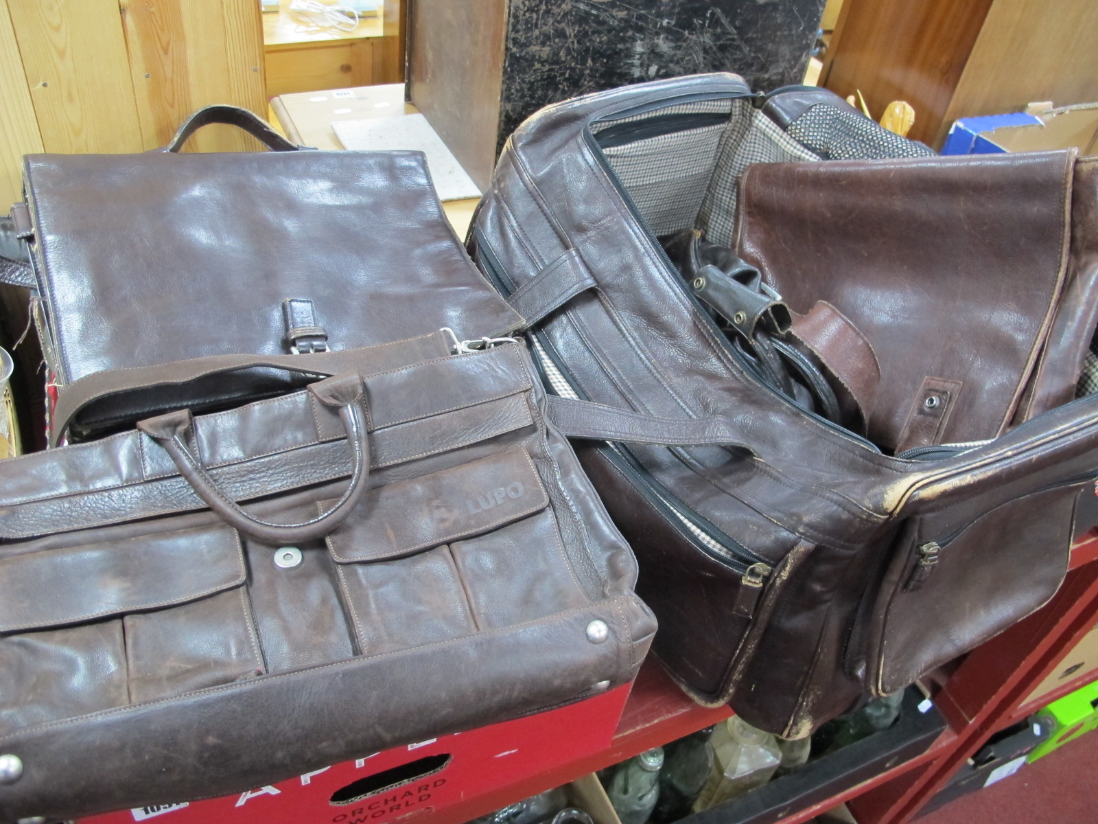 A Hidesign Brown Leather Holdall, with pull out handle and wheels, a smaller holdall, gents shoulder