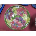 Moorcroft Pottery Clematis Pattern Floral Bowl, on green ground, 21cm diameter, bearing paper