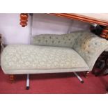 Chaise Longue, upholstered in an olive green moquette type fabric, on turned legs.