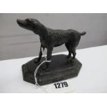 A XIX Century Cast Iron Paperweight as a Dog on Octagonal Plinth, 11cm wide (repair).