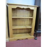 A Pine Bookcase, with moulded edge, reeded sides and two fixed shelves, on shaped plinth base,