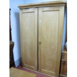 A XIX Century Light Ash double Wardrobe, with curved corners to stepped pediment and plinth base,