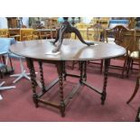 A 1920's Oak Gate Leg Table, with fall leaves to oval top, on barley twist supports.