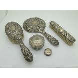 A Matched Hallmarked Silver Backed Three Piece Dressing Table Set, allover decorated in relief;