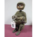 A Late XIX Century/Early XX Century Nodding Monkey, with moving eyes and mouth nursing a baby