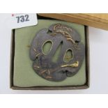 A Japanese Tachi Tsuba, Mokko Shape, unsigned, Edo period, Shakudo bird and tree design, in wooden