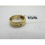 A Modern 9ct Gold Band Ring, with inset highlights, between textured finish, stamped "Dia" "05". (