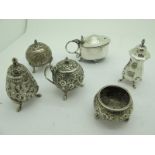 A Middle Eastern Three Piece Cruet Set, allover detailed in relief with leaf scrolls, a similar