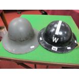 Two WWII Period British Helmets, one repainted black with letter W.