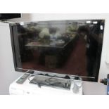 Panasonic TX-L32 Flat Screen TV and remote.