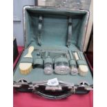 A Victorian Black Leather Ladies Travelling Case, containing silver topped jars (hallmarked