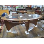 G-Plan Oval Shaped Teak Coffee Table, with curved cruciform base and glass inset top, 122cm wide.