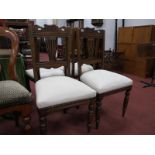 Four Early XX Century Stained Ash Chairs, with shaped top rail, upholstered seats, on turned front