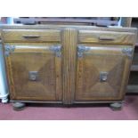 A 1940's Oak Sideboard, the top with cup and cover supports, base with two drawers over cupboard