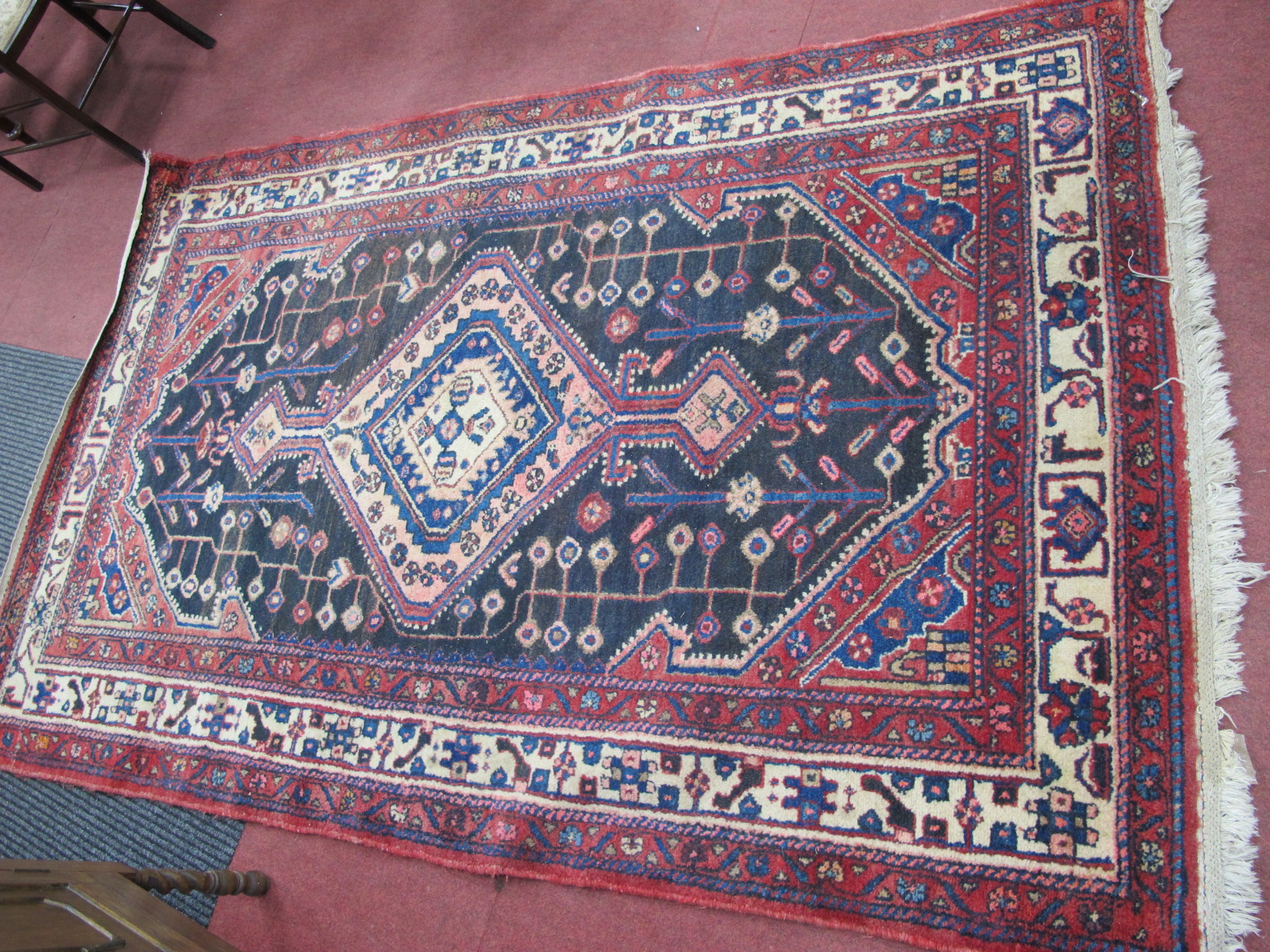 Middle Eastern Wool Tassles Rug, with allover geometric motifs on black and red ground, approx.