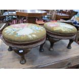 A Pair of Early XX Century Footstools, with circular floral woolwork panel tops, on cabriole legs