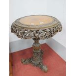 XIX Century Burmese Hardwood Snap Top Table, of circular form, heavily carved with foliage, on