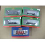 Four 1:76 Scale Narrow gauge Wagons, by Bachmann, plus a "OO" Scale Seven plank Wagon by Bachmann,