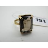 A Large 9ct Gold Dress Ring, with a four claw rectangular centre, between plain tapered shoulders (