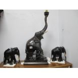 Ebonised Table Lamp as an Elephant, 66cm high excluding fittings and pair of elephant ornaments. (