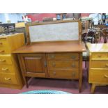 And Edwardian Mahogany Washstand, having three drawers by cupboard, on tapering legs, 107cm wide.