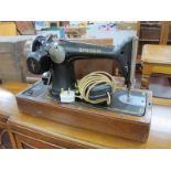 Singer Sewing Machine, in oak dome case.