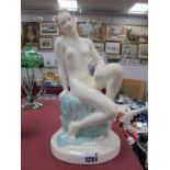 Continental Pottery Figure of a Seated Nude Lady, on blue sheet, circa 1920's wearing yellow wrist