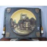 A Shellcraft Porcel Ware Wall Clock, in ceramic village scene plaque within rectangular shield