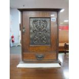 Early XX Century Oak Table Top Smokers Cabinet, with oxidized panel to single door concealing fitted