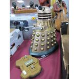 A 33cm Tall Battery Operated Dalek, in gold.