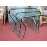 A Nest of Three Glass Coffee Tables, with shaped sides (some damages).